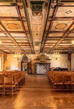 Innenaufnahme Saal im Schloss Wilhelmsburg mit Stühlen, Kronleuchtern und Wandverzierungen